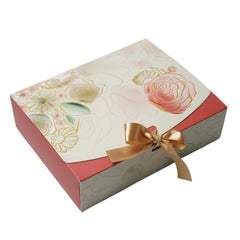 Gift box with floral design and gold ribbon on a white background