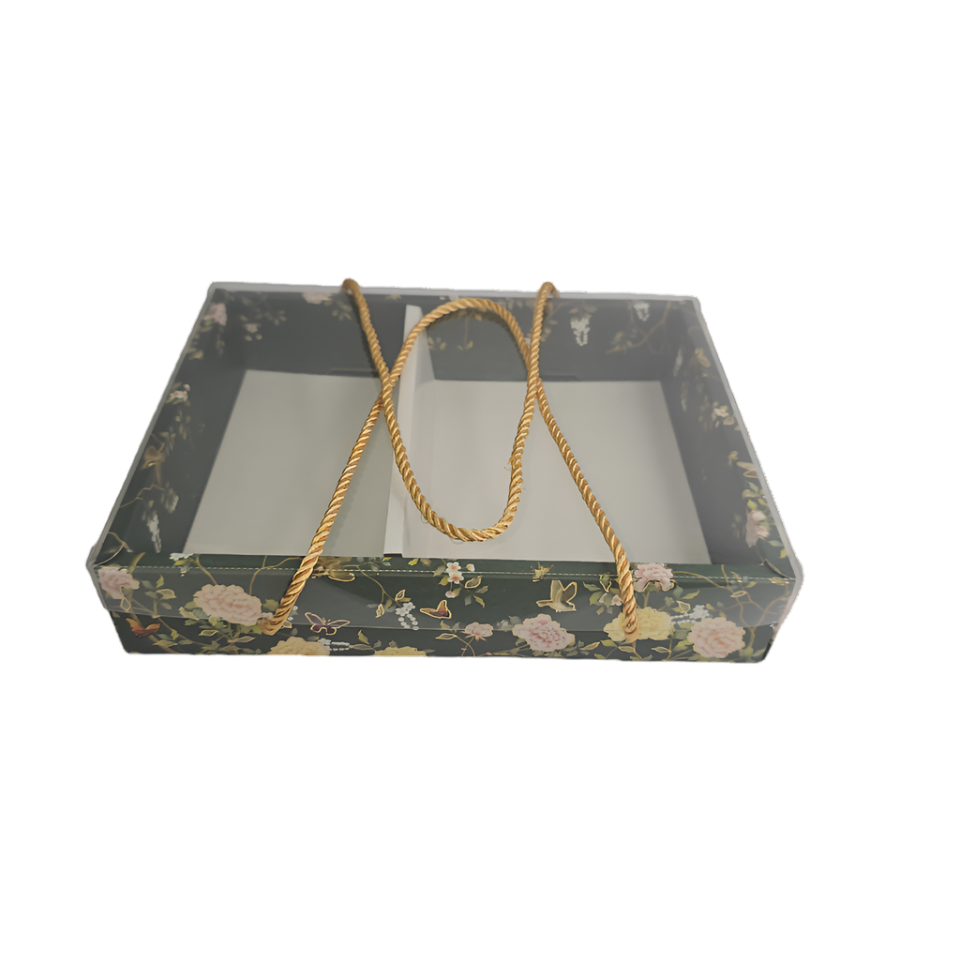 Decorative box with floral pattern and gold string on a white background